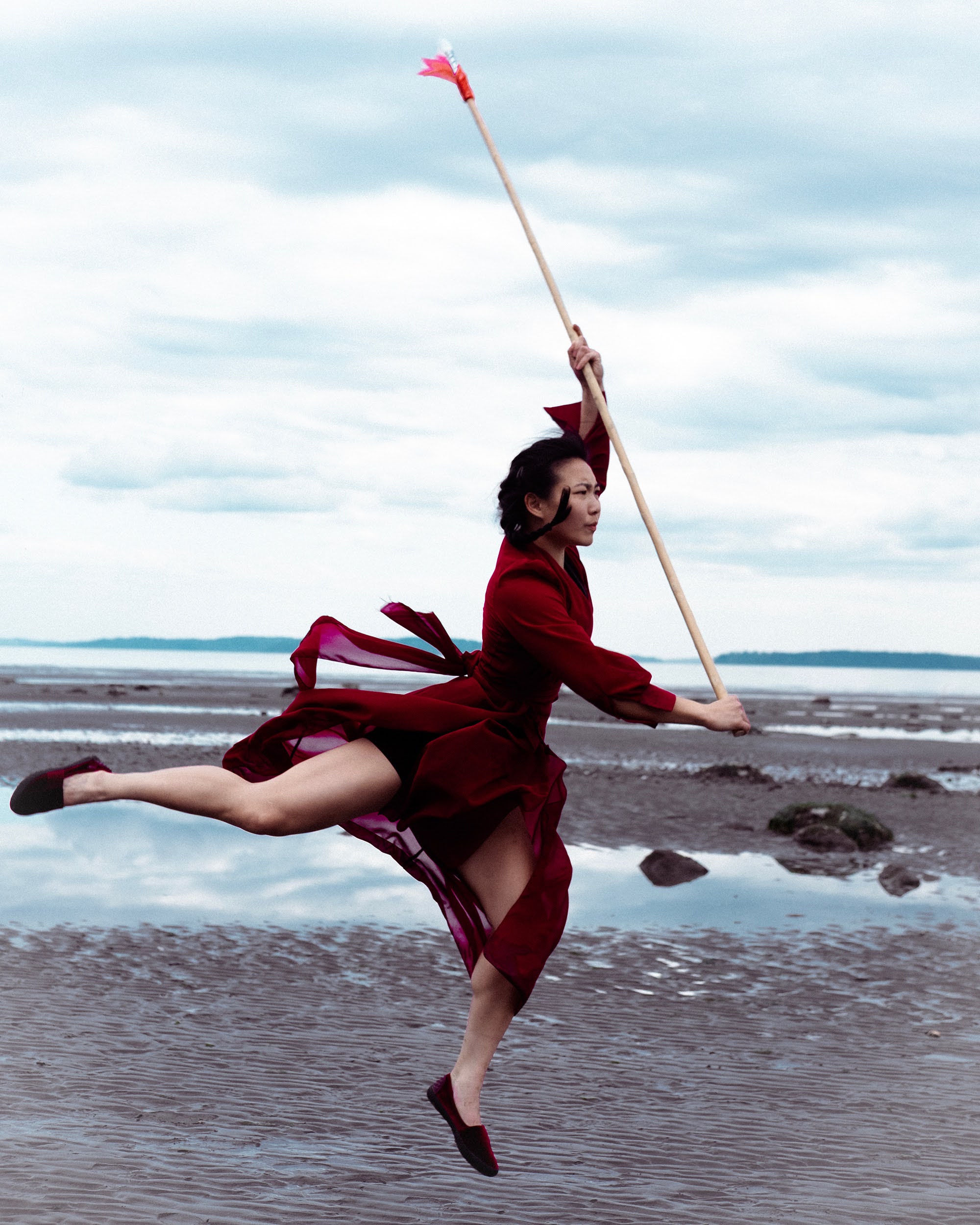 Flying spear leap on a beach at low tide
